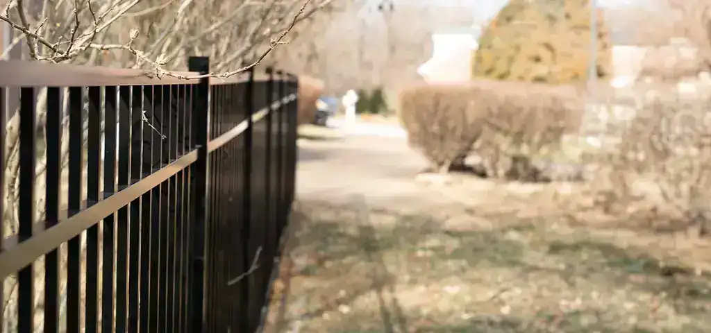 Powder coated aluminum fencing along a residential boundary