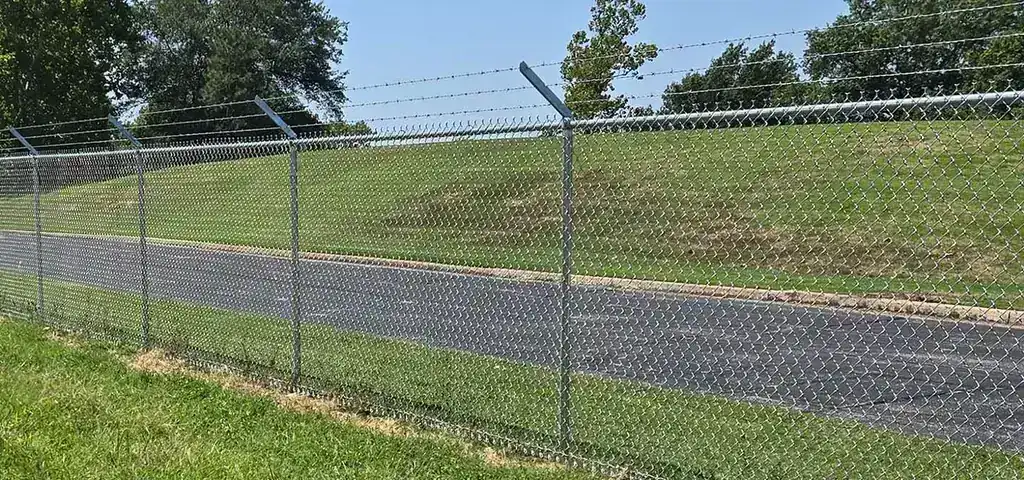 Galvanized chain link fencing with top rail installed by Aaron Fence